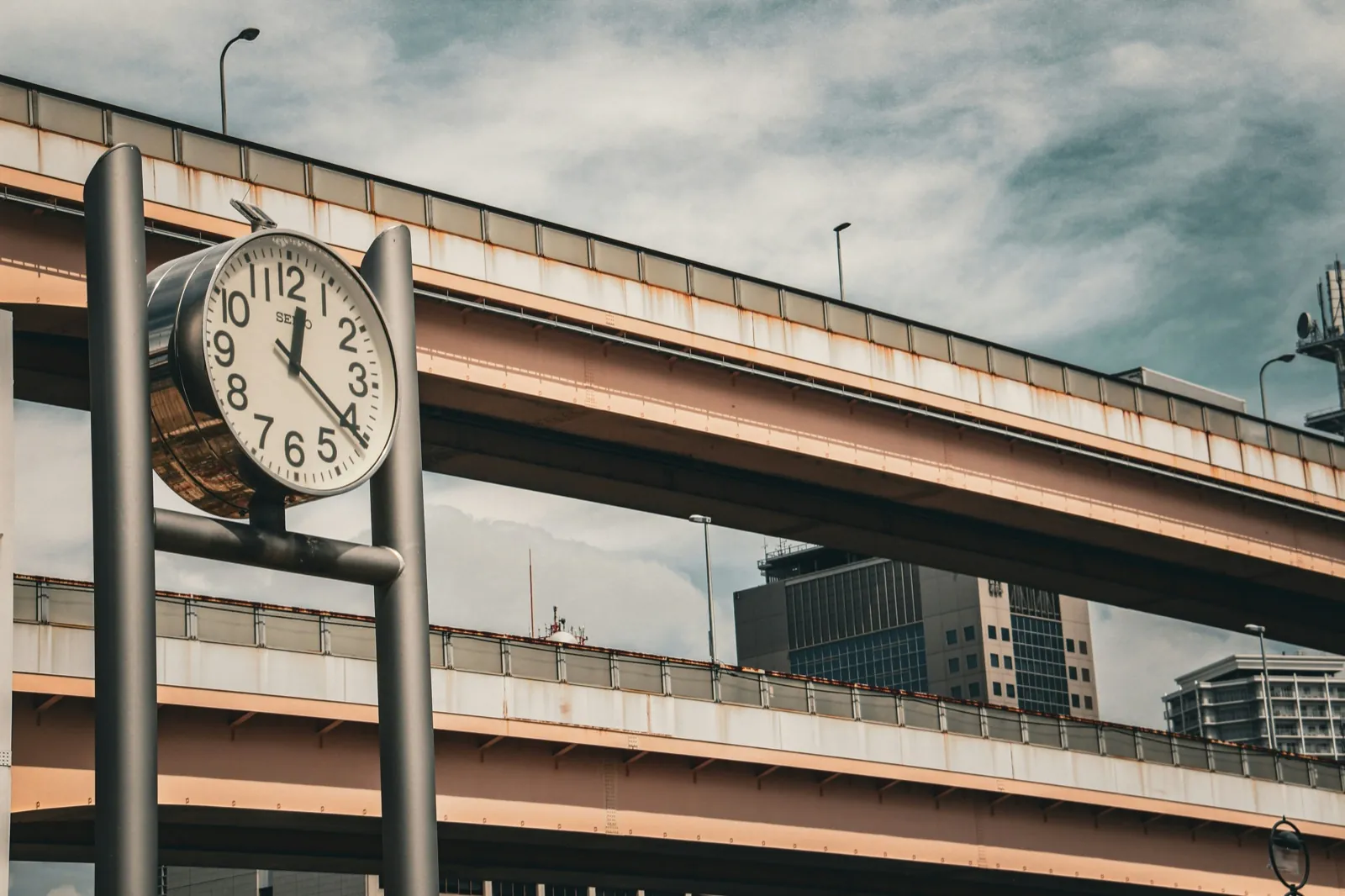 Reloj urbano junto a autopistas elevadas — hora oficial en Japón en tiempo real